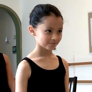 Child with a smile during Junior Ballet at Summerschool Den Haag
